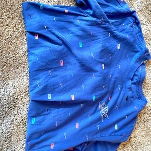 Blue medium Nike shirt with different color Nike checks all over it